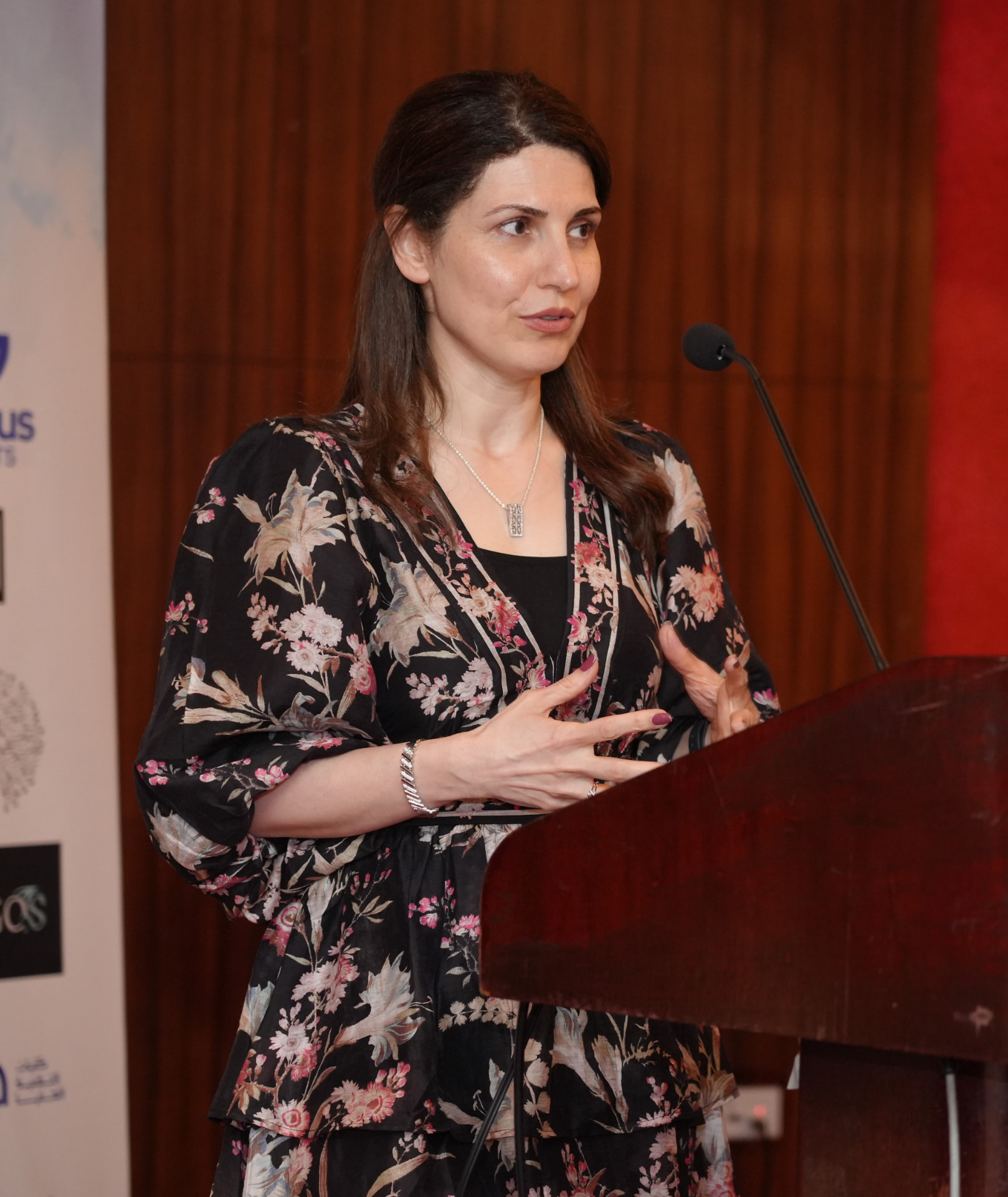 Dr. Neda Maria Kaizumi speaking at a podium